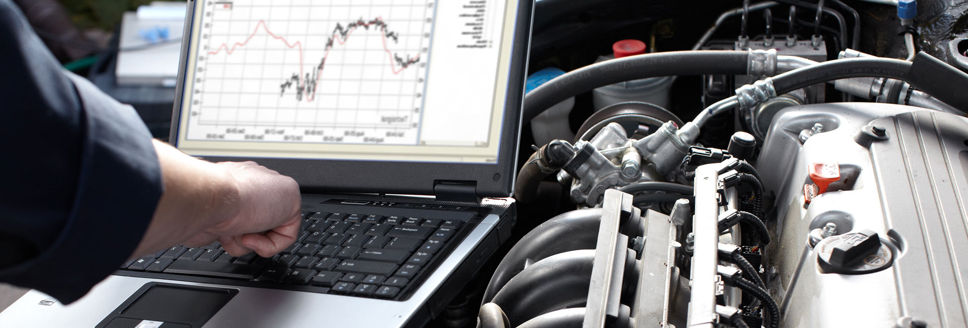 Mechanic Examining Car Engine Using Diagnostic Machine Tools